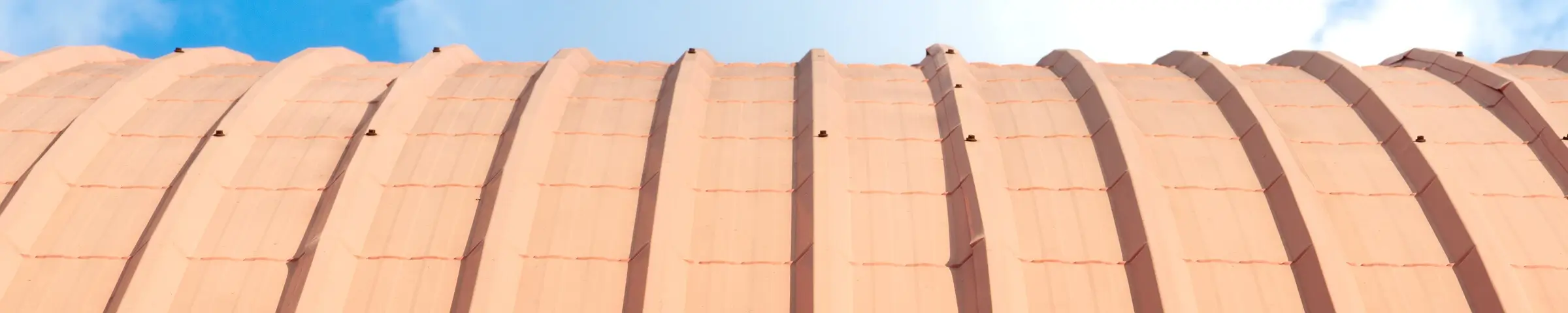 MetalForming sells standing seam and roof curving machines. This shows an example of a curved roof formed by a standing seam machine.